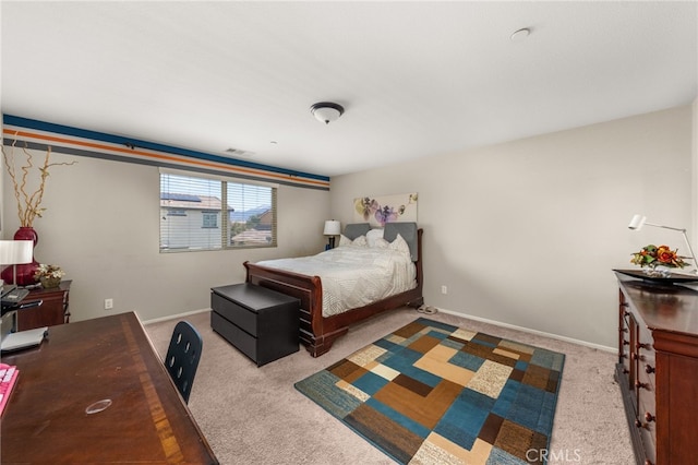 carpeted bedroom featuring visible vents and baseboards
