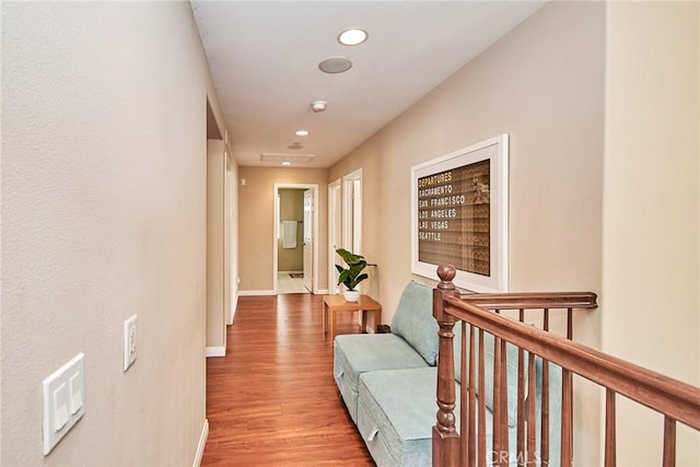corridor with recessed lighting, an upstairs landing, baseboards, and wood finished floors
