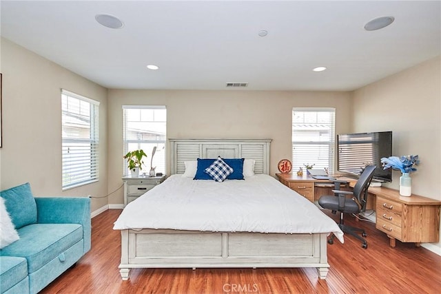 bedroom featuring recessed lighting, visible vents, multiple windows, and wood finished floors