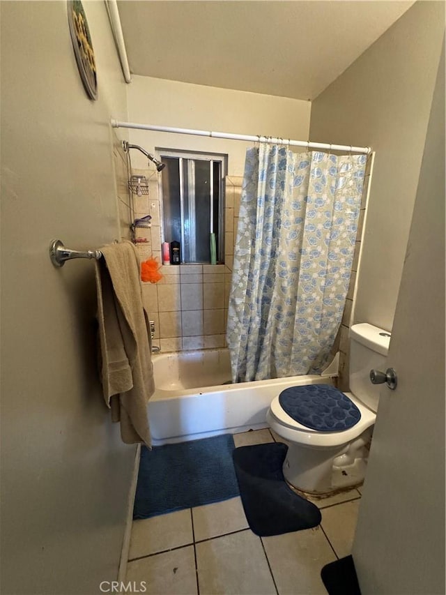 bathroom with tile patterned floors, toilet, and shower / tub combo with curtain