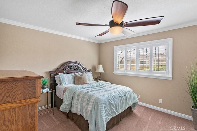 carpeted bedroom featuring crown molding, ceiling fan, and baseboards