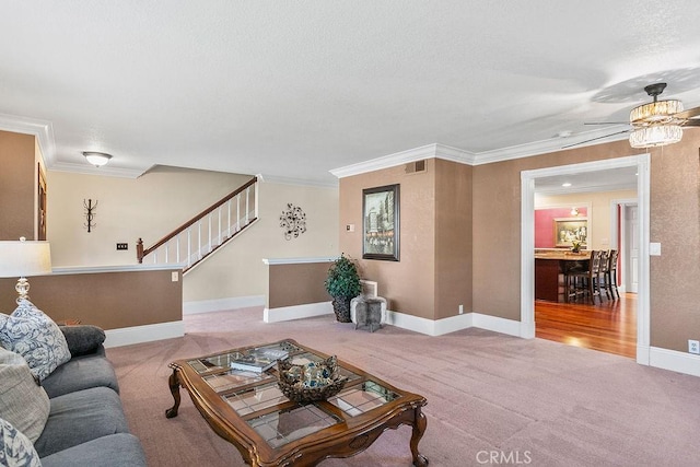 living room featuring carpet flooring, ornamental molding, visible vents, and stairs