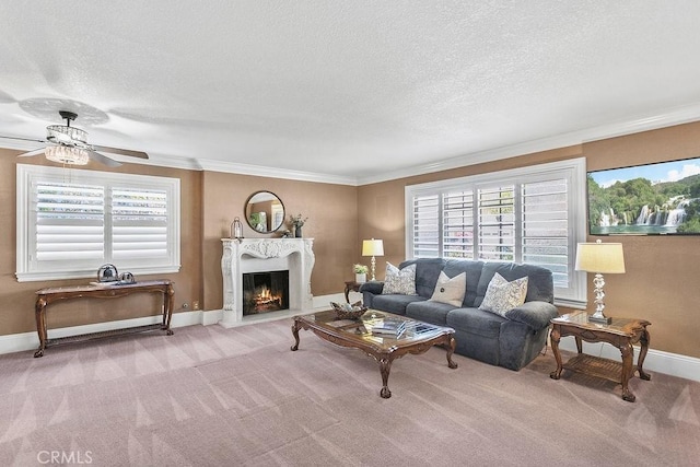 carpeted living room featuring a textured ceiling, a high end fireplace, baseboards, and a ceiling fan