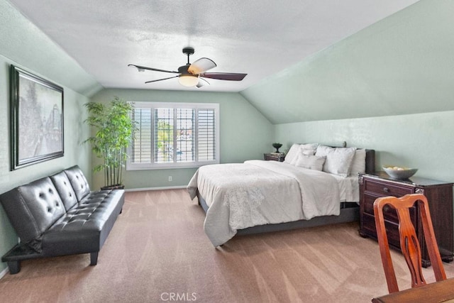 bedroom with a ceiling fan, baseboards, lofted ceiling, and carpet