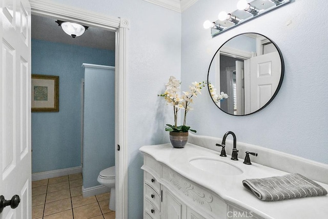bathroom with crown molding, toilet, tile patterned flooring, and vanity