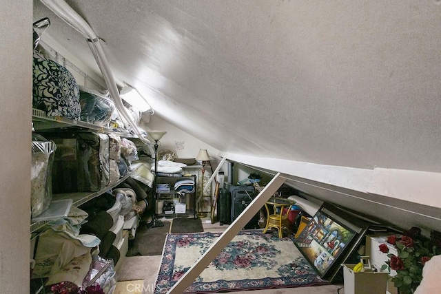 bonus room with a textured ceiling and lofted ceiling
