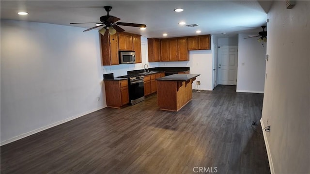 464 W E St, Colton, CA 92324 - kitchen with appliances with stainless steel finishes, ceiling fan, dark countertops, baseboards, and dark wood-style floors