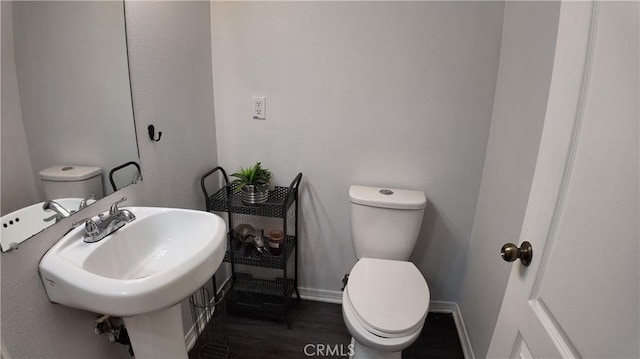 464 W E St, Colton, CA 92324 - bathroom featuring toilet, baseboards, wood finished floors, and a sink