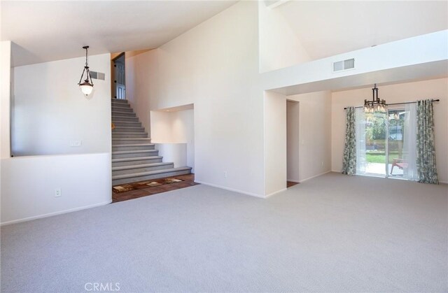 41768 Via El Greco, Temecula, CA 92592 - unfurnished living room featuring carpet floors, baseboards, high vaulted ceiling, a chandelier, and stairs