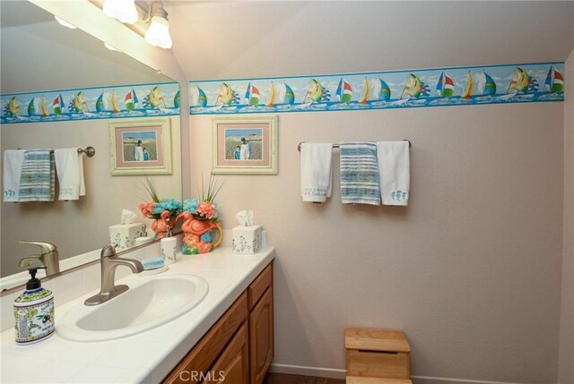 bathroom featuring vanity and vaulted ceiling