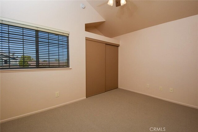 unfurnished bedroom featuring a closet, a ceiling fan, carpet, and baseboards