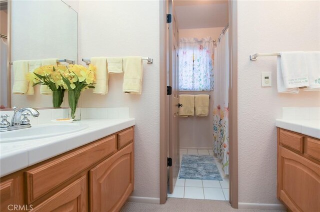 full bath with vanity, tile patterned floors, and a shower with shower curtain