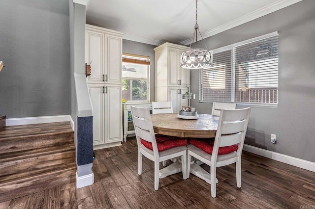 dining room with a chandelier, crown molding, dark wood-style flooring, and baseboards