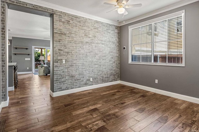 unfurnished room featuring wood finished floors, brick wall, crown molding, and ceiling fan