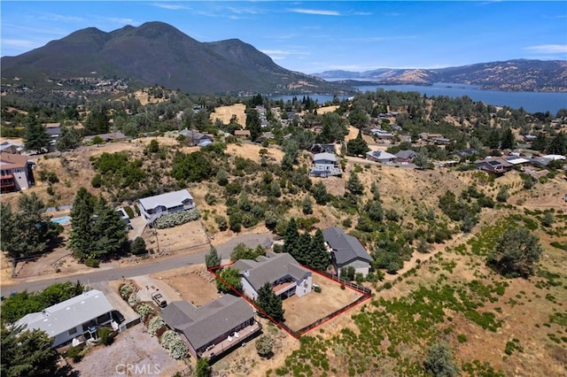 birds eye view of property with a water and mountain view and a residential view