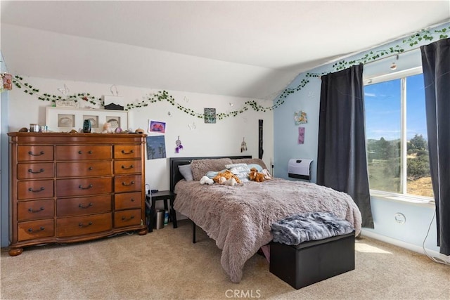 bedroom with light carpet, multiple windows, and lofted ceiling