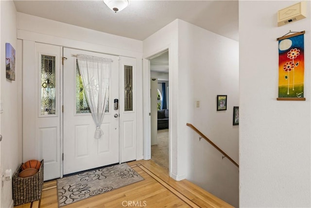 foyer entrance with light wood finished floors