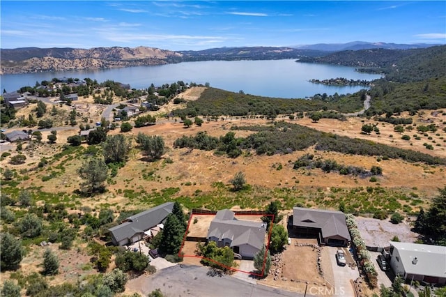 drone / aerial view featuring a water and mountain view