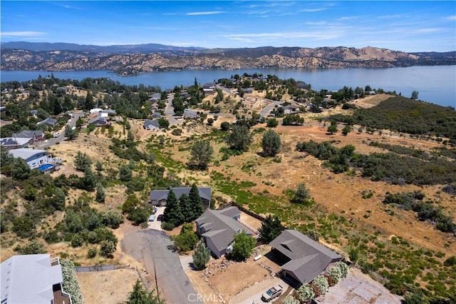 drone / aerial view with a water and mountain view