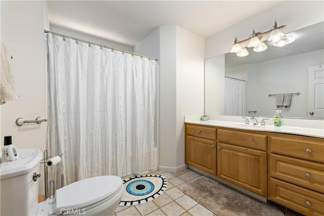 full bathroom featuring toilet, vanity, and tile patterned flooring