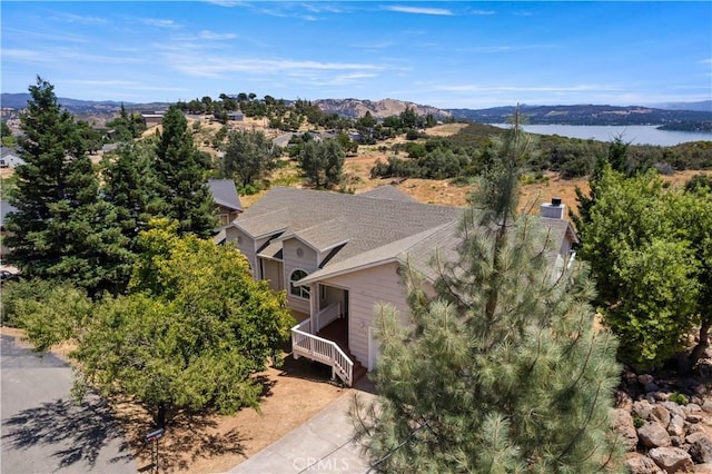 birds eye view of property with a water and mountain view