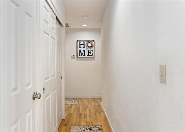 corridor with recessed lighting, light wood-style floors, and baseboards