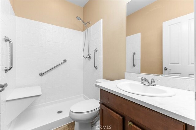 17938 Caraway Ct, San Bernardino, CA 92407 - bathroom with vanity, a tile shower, and toilet