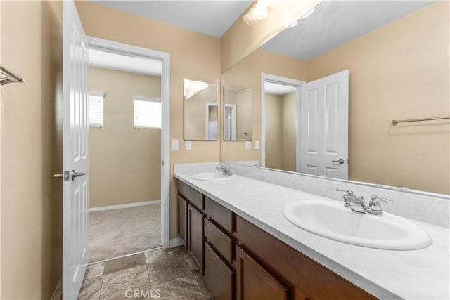 17938 Caraway Ct, San Bernardino, CA 92407 - bathroom with double vanity, baseboards, and a sink