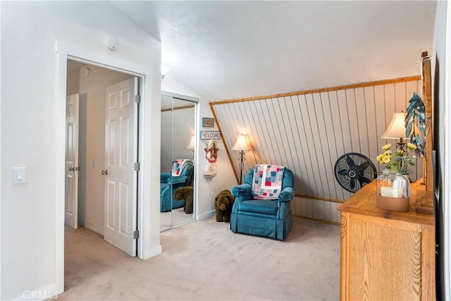 sitting room with baseboards, carpet flooring, and lofted ceiling
