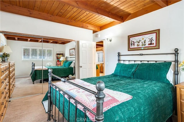 bedroom with wood ceiling, carpet flooring, and beam ceiling