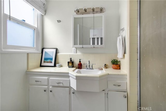 bathroom featuring tasteful backsplash and vanity