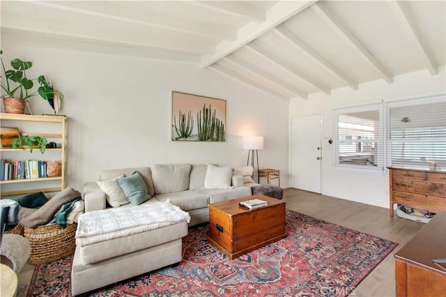 living room featuring wood finished floors and vaulted ceiling with beams