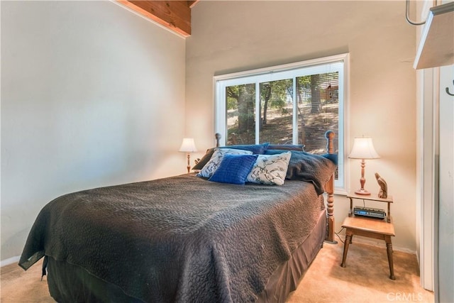 bedroom featuring baseboards and light carpet