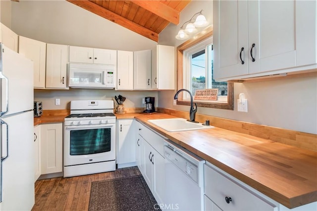 kitchen featuring white appliances, vaulted ceiling with beams, wood ceiling, a sink, and wood counters