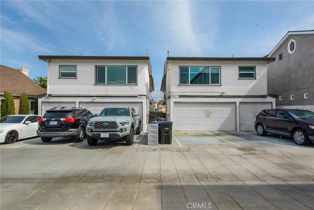 view of front of property featuring a garage and stucco siding