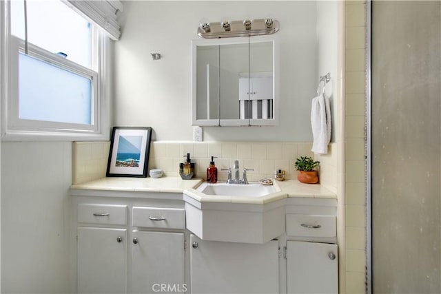 bathroom featuring tasteful backsplash and vanity