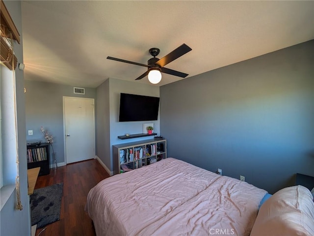 bedroom featuring visible vents, ceiling fan, wood finished floors, and baseboards