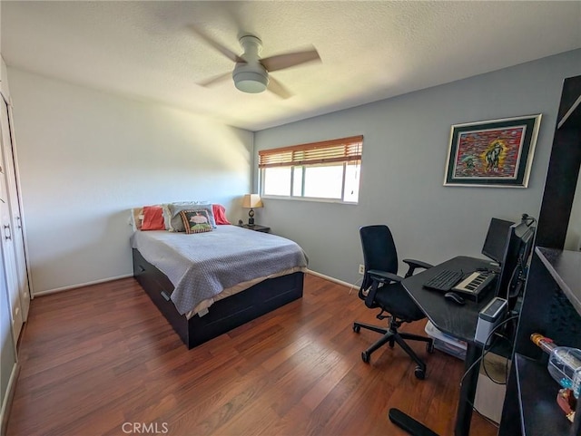 bedroom featuring ceiling fan, wood finished floors, and baseboards