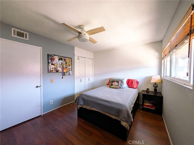bedroom with visible vents, ceiling fan, wood finished floors, and baseboards