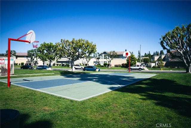 view of basketball court with community basketball court, a yard, and a residential view