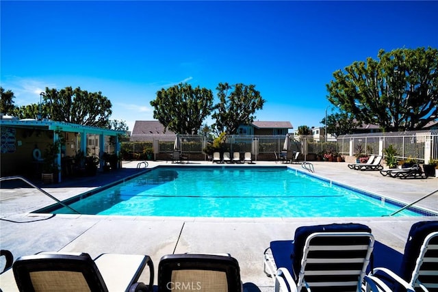 pool with fence and a patio