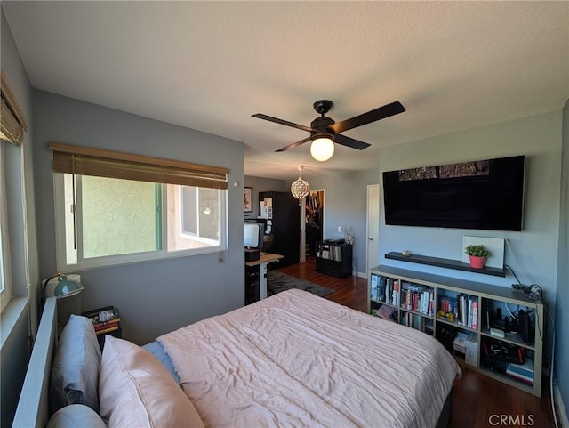 bedroom with wood finished floors and ceiling fan