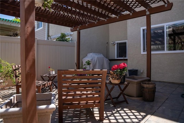 view of patio / terrace with a pergola, outdoor dining space, a grill, and fence