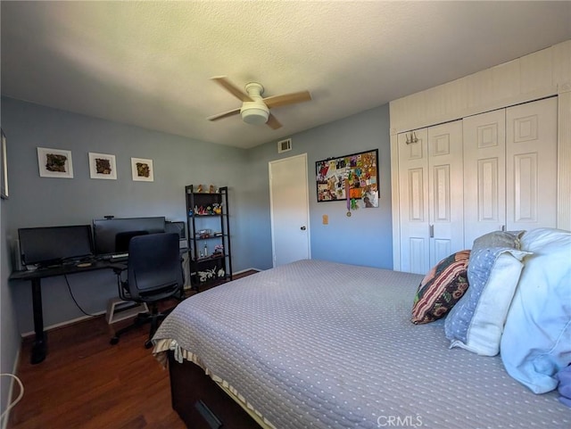 bedroom with a closet, visible vents, a ceiling fan, and dark wood-type flooring