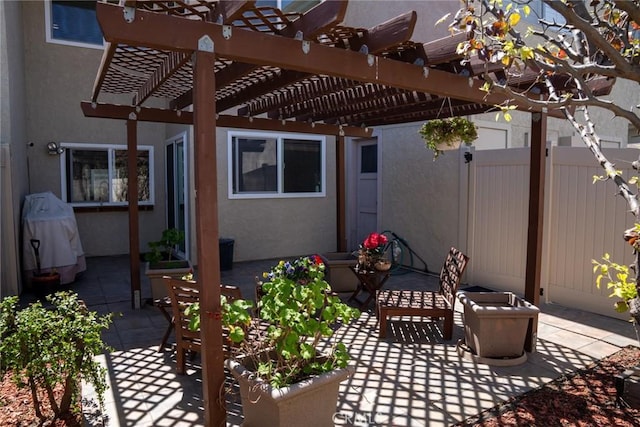 view of patio featuring fence and a pergola