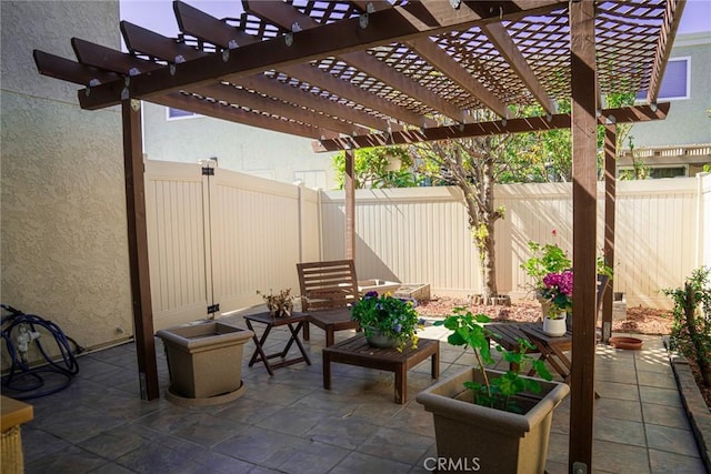view of patio / terrace with a fenced backyard and a pergola