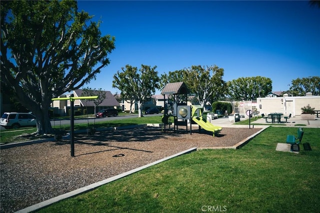 communal playground featuring a lawn