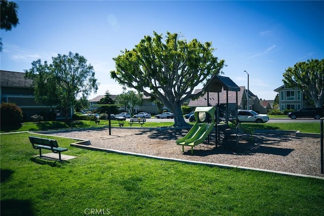 community playground featuring a yard and a residential view