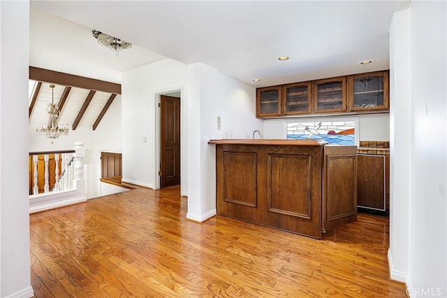 bar featuring indoor wet bar, a notable chandelier, baseboards, recessed lighting, and light wood-style flooring