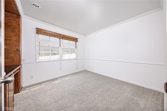 spare room with ornamental molding, baseboards, and carpet floors